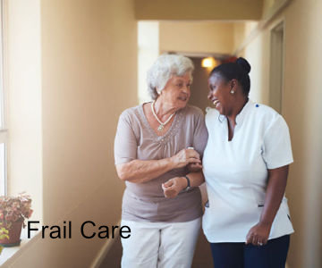 nurse holding a resident and smiling