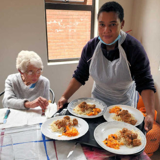 nurses making a frail care resident comfortable